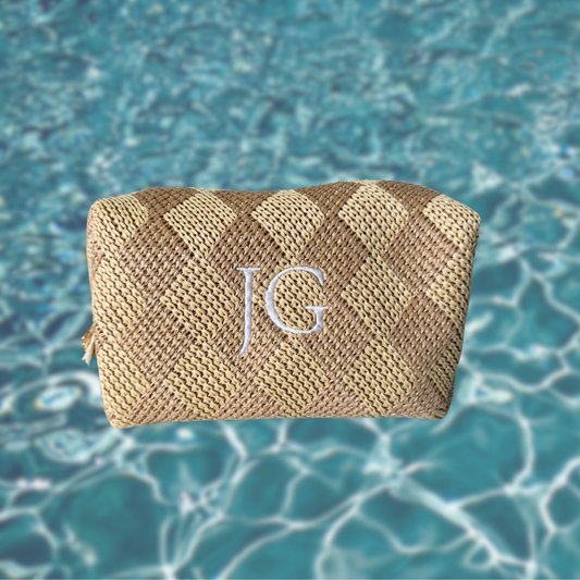 Woven pouch with 'JG' monogram on a blue water background